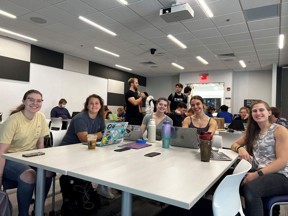 RITSEC members working on their computers at a general meeting.